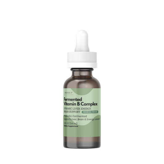 A small amber glass dropper bottle with a white cap and a pale green label, centered on a plain white background. The label text appears to read 'Soyfermented Vitamin B Complex'.