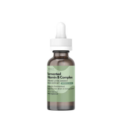 A small amber glass dropper bottle with a white cap and a pale green label, centered on a plain white background. The label text appears to read 'Soyfermented Vitamin B Complex'.